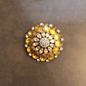 Yellow and white brooch.